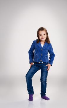 Little Girl In Blue Jeans And Jacket Posing In The Studio Stock Photo Little Girl In Blue Jeans And Jacket Posing In The Studio Stock Photo