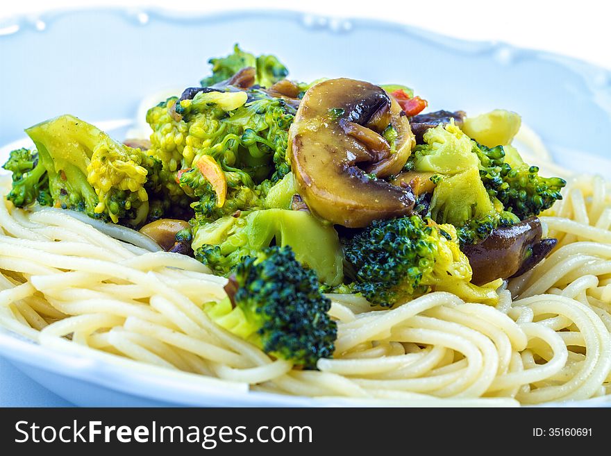 Spaghetti with broccoli mushrooms and olive oil.