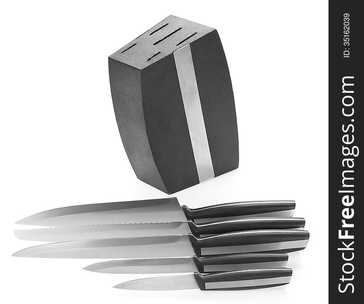 Five steel kitchen knives and knife block isolated on white