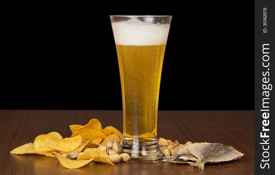 Glass Of Foamy Beer With Bubbles, Chips, Salty