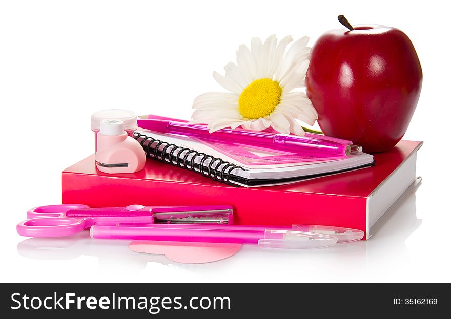 The book, a notepad, handles, pencil, scissors, a puncher, paint and red apple isolated on white. The book, a notepad, handles, pencil, scissors, a puncher, paint and red apple isolated on white