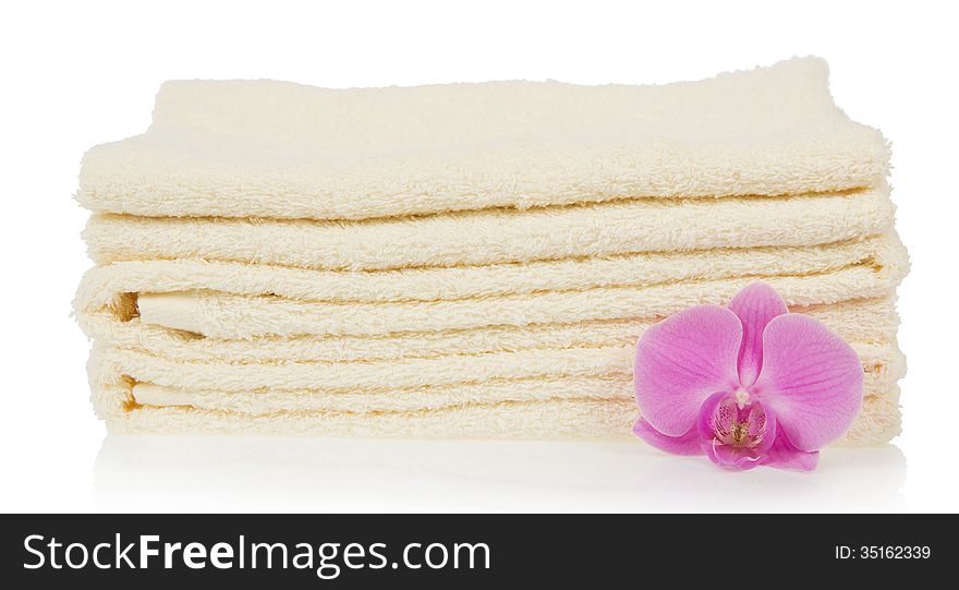 The bathing towels decorated with a flower of an orchid, isolated on white. The bathing towels decorated with a flower of an orchid, isolated on white