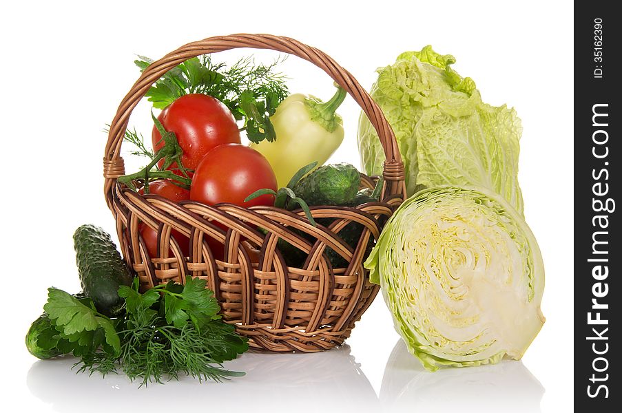 The whole cabbage, piece of cabbage, cucumber, greens and basket with the vegetables, isolated on white. The whole cabbage, piece of cabbage, cucumber, greens and basket with the vegetables, isolated on white