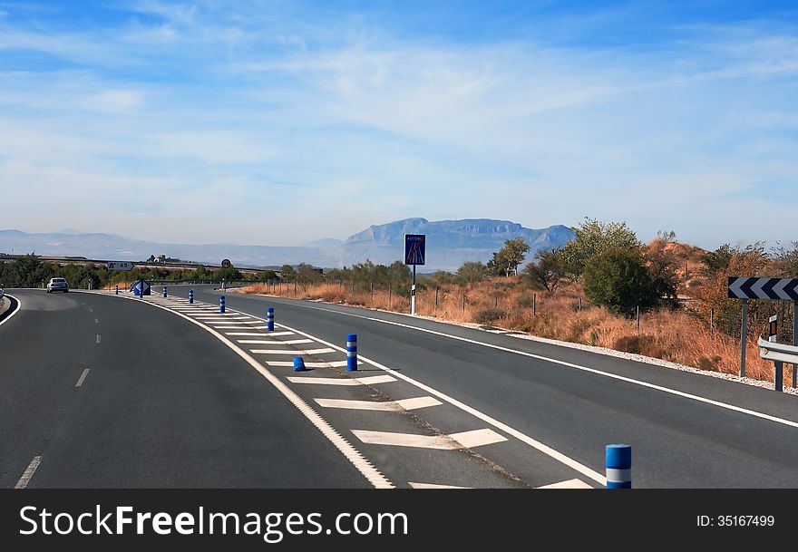 Empty winding road on background with blue sky