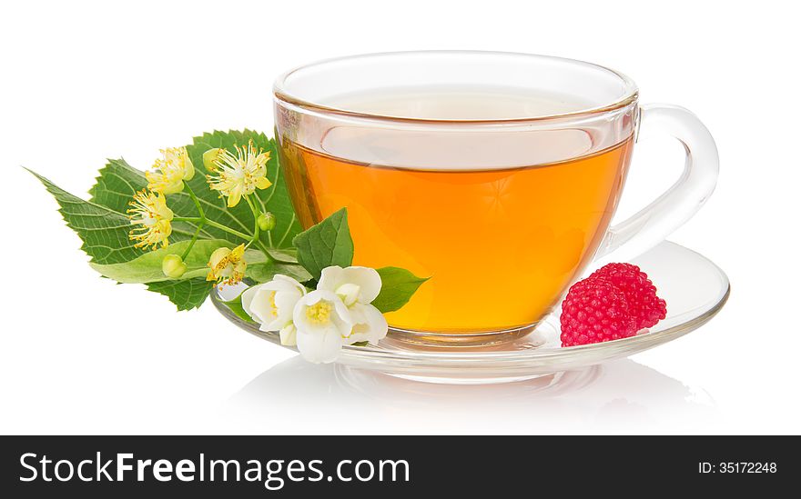 Cup of tea with a saucer, jasmine and linden flower, raspberry isolated on white