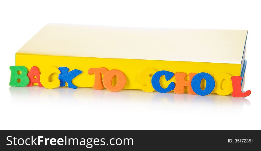 The book and set of plastic letters for the training, isolated on white. The book and set of plastic letters for the training, isolated on white