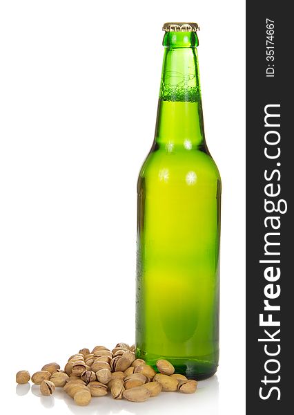 Bottle of beer and the fried pistachios isolated on white. Bottle of beer and the fried pistachios isolated on white