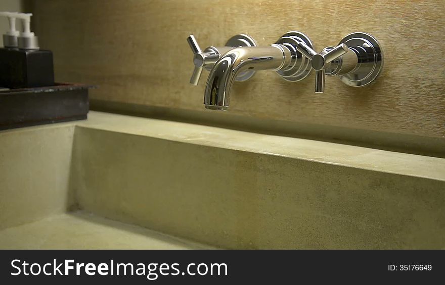 Hand open and close water tap faucet in the bathroom