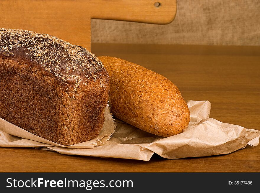 Freshly baked traditional bread on wooden board