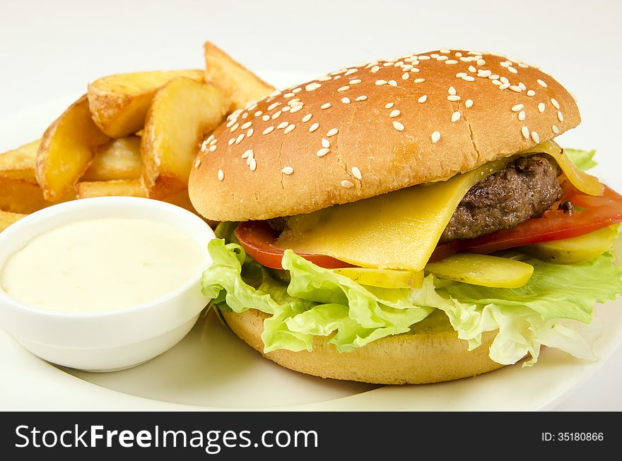 Hamburger with fries and sauce