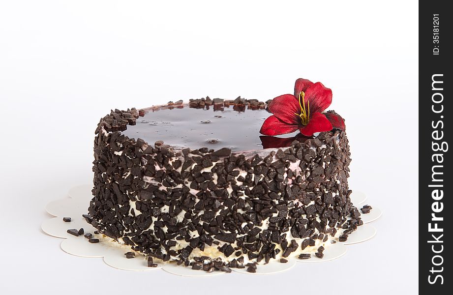 Chocolate Cake with Chocolate on uneven light background, cake isolated on warm light background with selective focus and uneven l