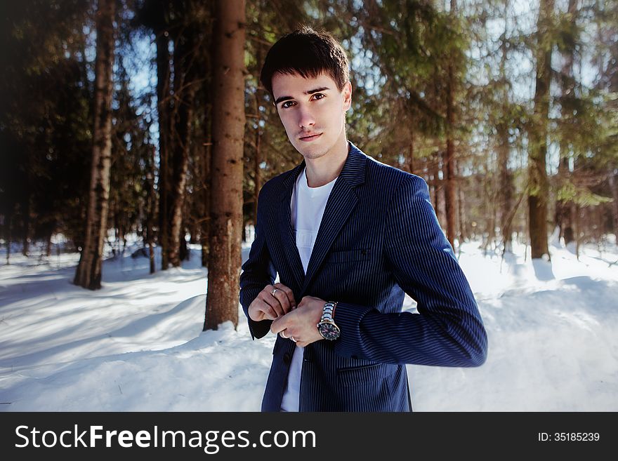 Portrait of a man in suit in snow forest