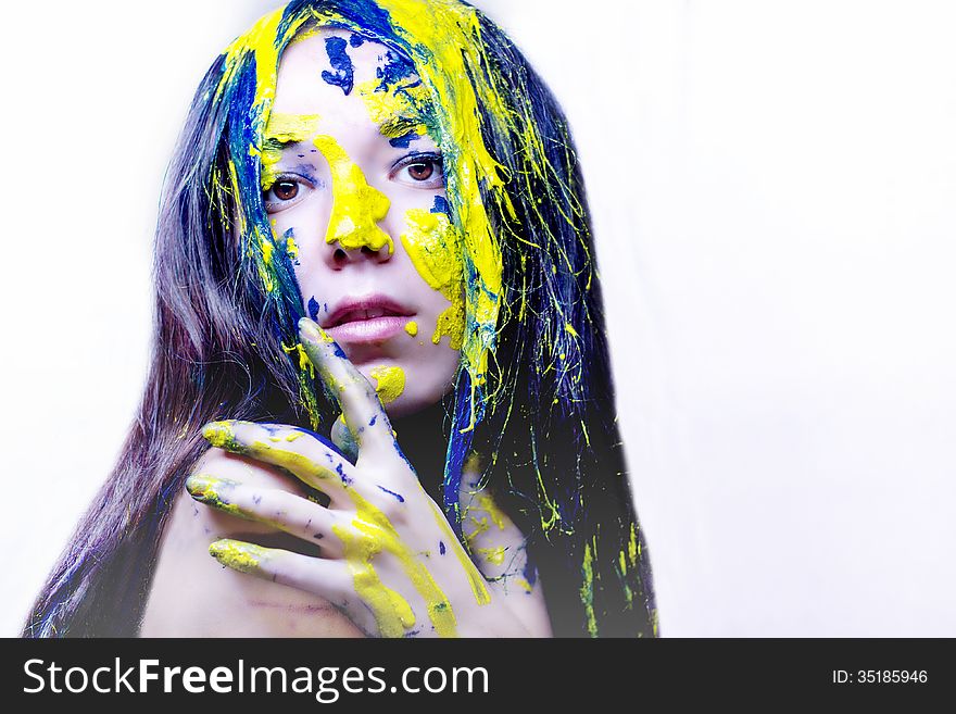 Beauty Portrait Of Woman Painted Blue And Yellow On White Background