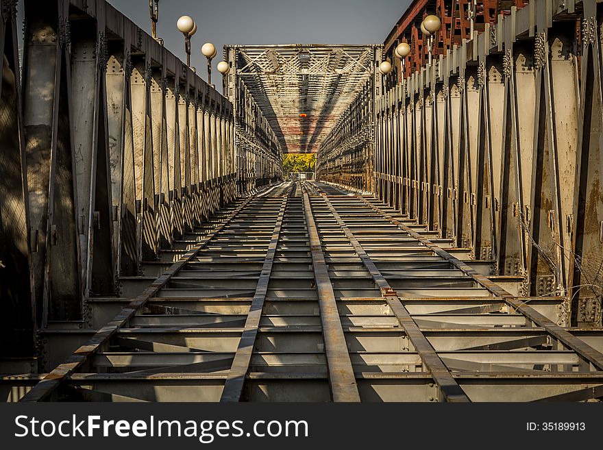 View down the bridge over the river in Bratislava. A pattern shot showing bridge girders. View down the bridge over the river in Bratislava. A pattern shot showing bridge girders