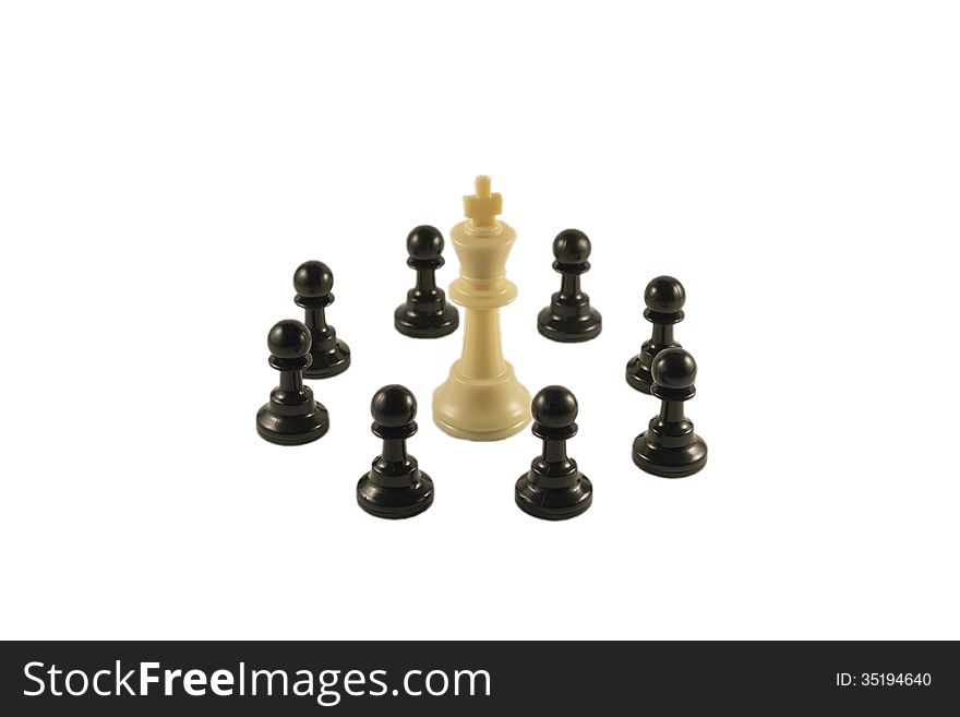 White king surrounded by the black pawns in a circle formation