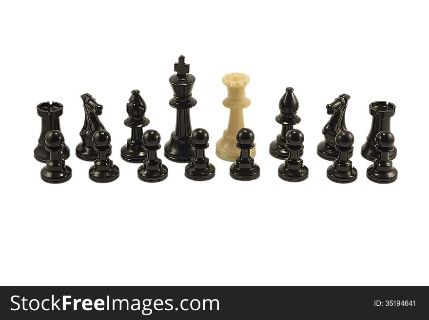 White queen standing alongside with the black chess pieces. White queen standing alongside with the black chess pieces