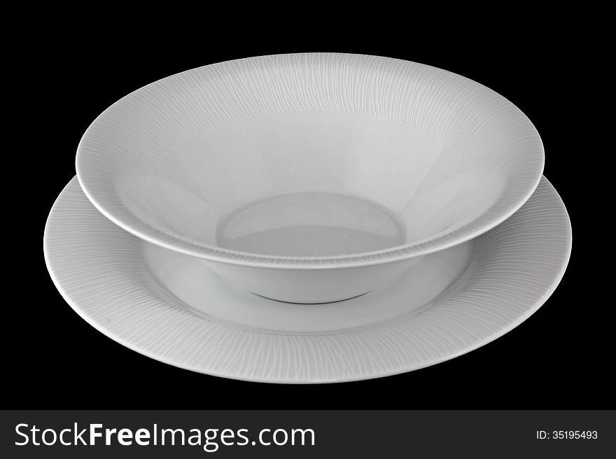 Set porcelain dinner plates on a black background. Set porcelain dinner plates on a black background.