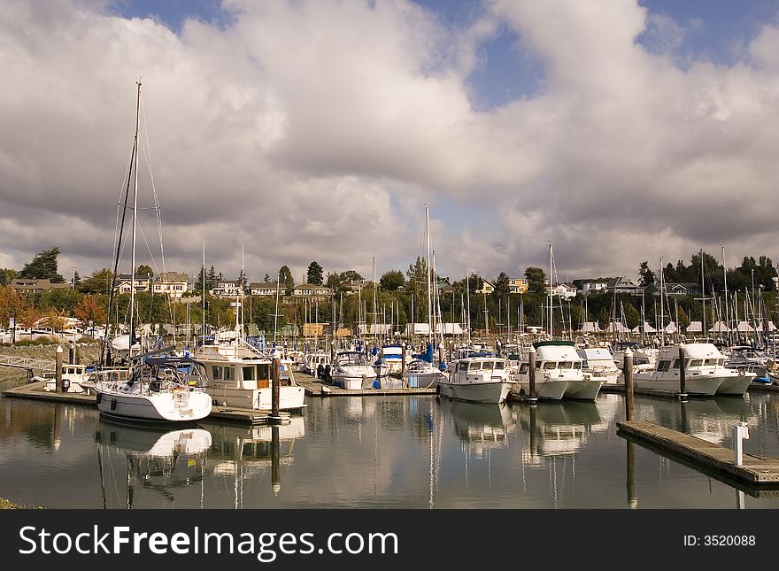 Yachts and sailboats at a marina with stormy skies. Yachts and sailboats at a marina with stormy skies