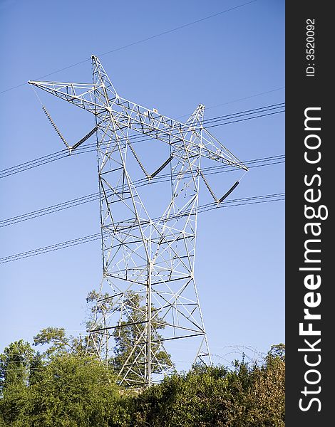 A high power tower against blue sky. A high power tower against blue sky