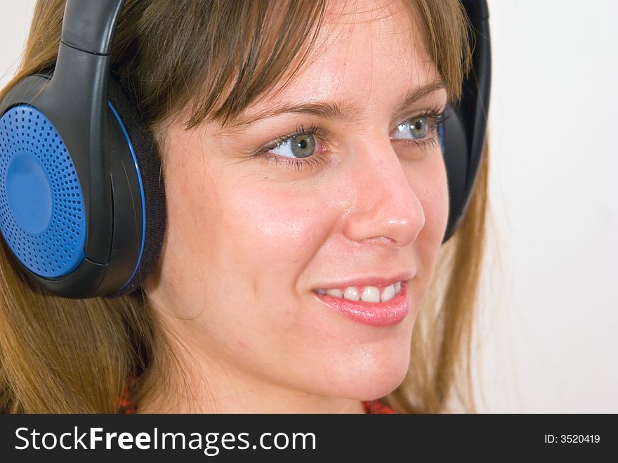 A girl, wearing headphones, listening to some music. A girl, wearing headphones, listening to some music