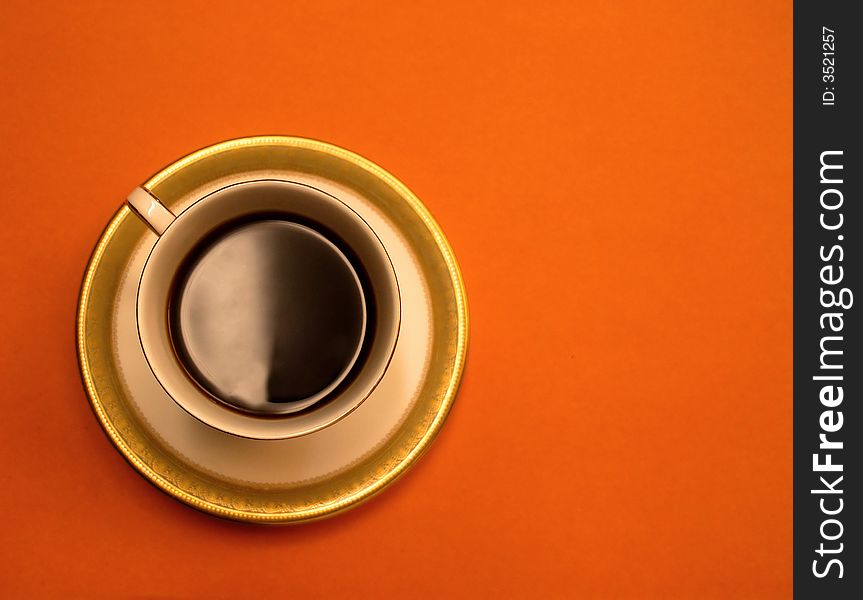 Black coffee cup with orange background