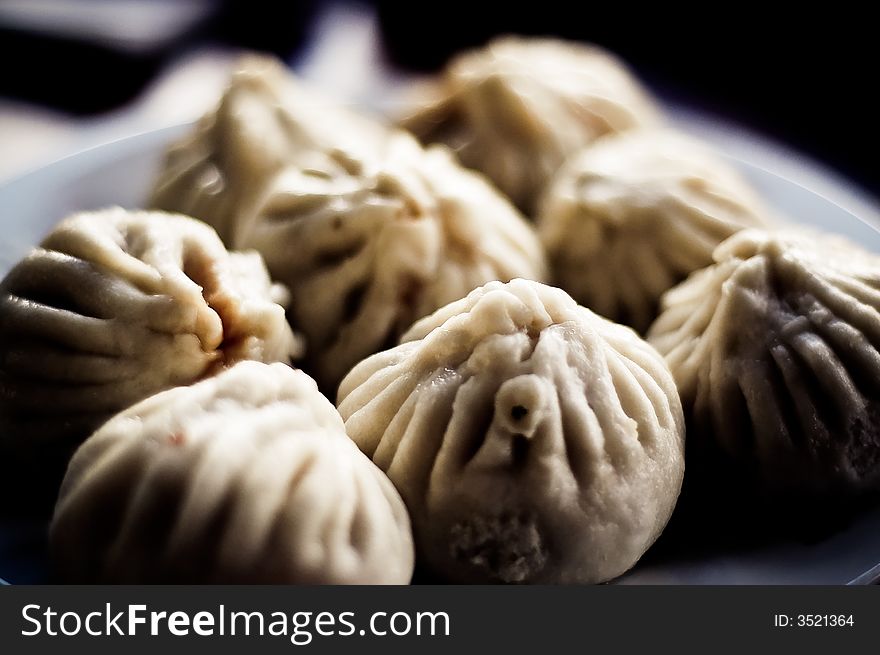 Chinese steamed buns on a plate.