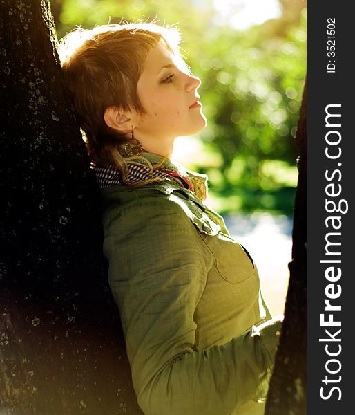 Cute girl in Scarf near tree.