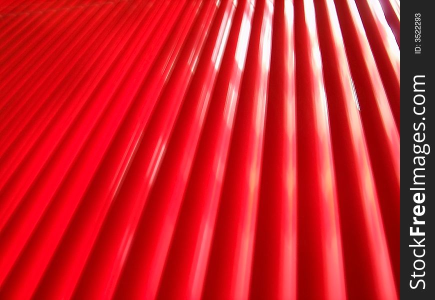 Red venetian blinds with a glowing light coming through them. Red venetian blinds with a glowing light coming through them.