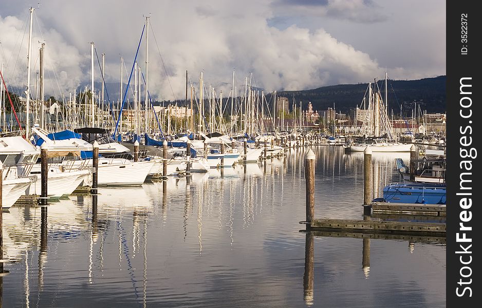 Yachts and sailboats in their slips at the marina. Yachts and sailboats in their slips at the marina