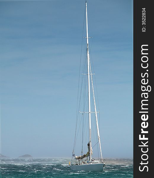 Sailing yacht in stormy weather sea with waves