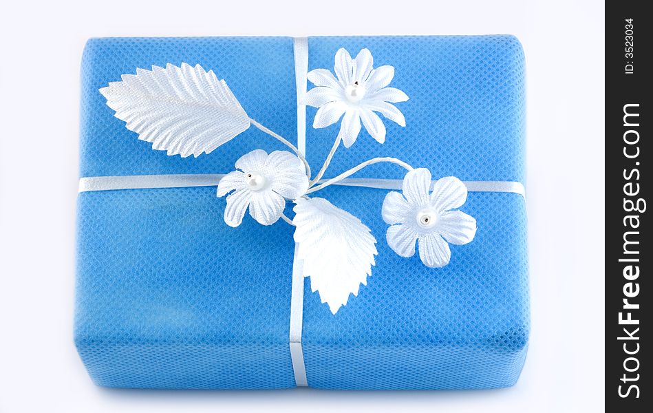 Lightblue gift box with white ribbon isolated on white