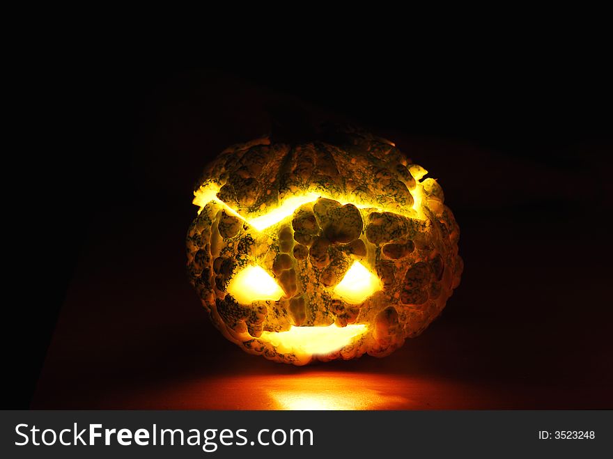 Little pumpkin -candle inside against black background. Little pumpkin -candle inside against black background