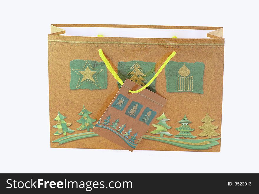 A brown christmas gift bag isolated on white. A brown christmas gift bag isolated on white.