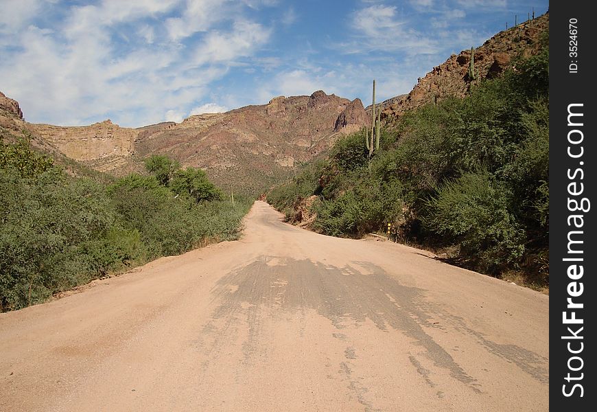 The picture of the dirt road taken on Apache Trail in Arizona. The picture of the dirt road taken on Apache Trail in Arizona.