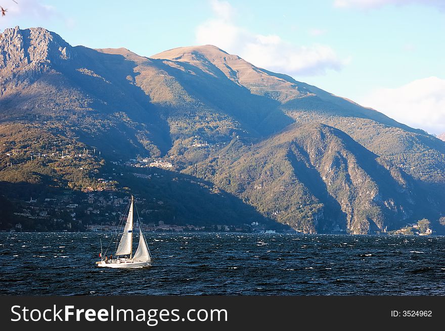 Small sailboat sailing in Como Lake, Italy. Small sailboat sailing in Como Lake, Italy