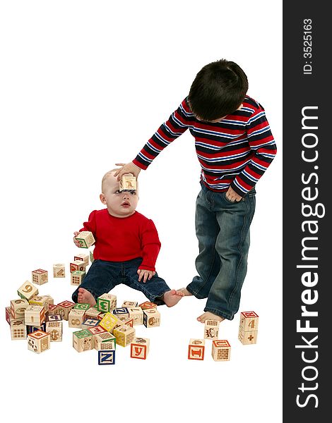 Brother and sister playing with blocks over white.  Clipping path included. Brother and sister playing with blocks over white.  Clipping path included.