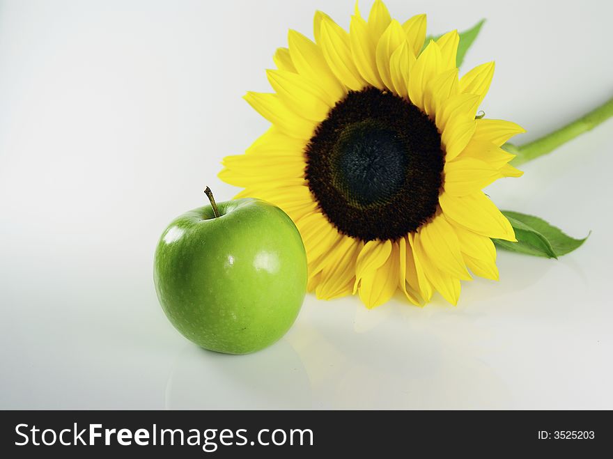 Sunflower and an green apple