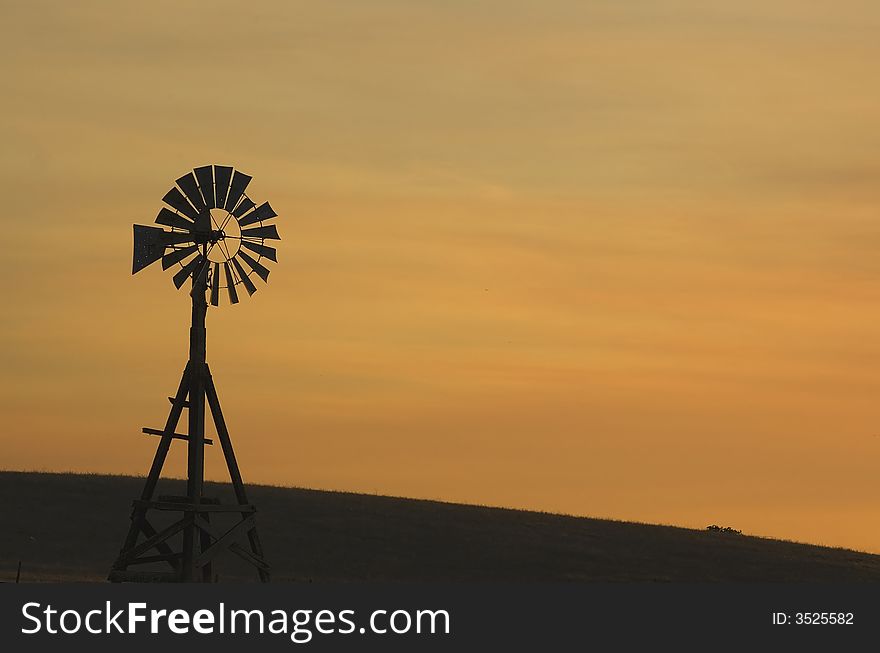 Windmill against an orange sky