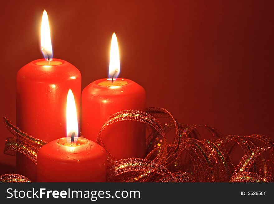 Three candles on red background