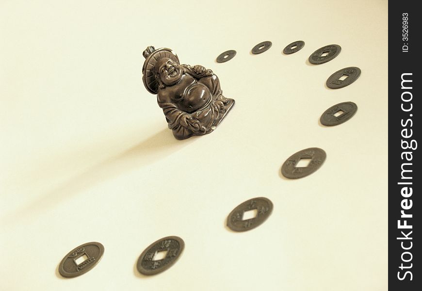 Figure of laughing Buddha with arc of chinese coins. Figure of laughing Buddha with arc of chinese coins