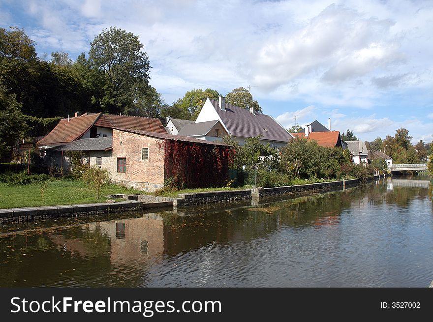 Several houses built close a river. Several houses built close a river