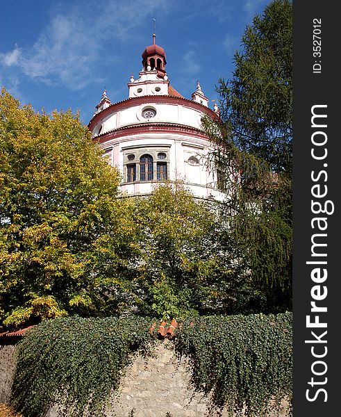 A tower of a posh house behind trees. A tower of a posh house behind trees