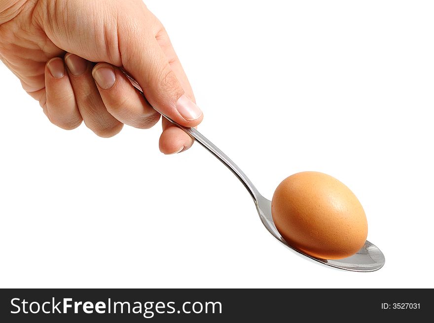 Male hand with a spoon  and egg