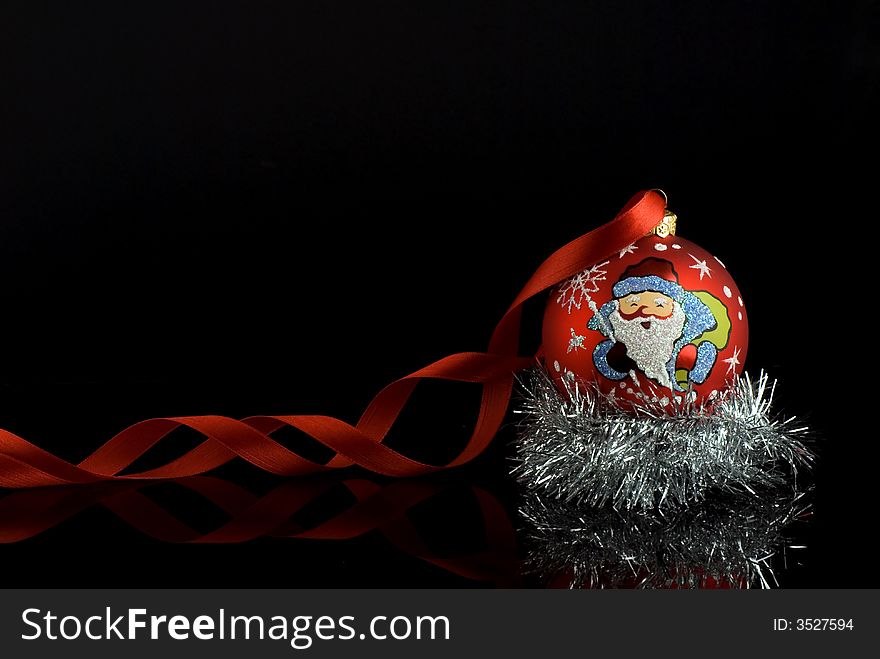 Red christmas tree ball with santa and red ribbon with reflection. Place for text