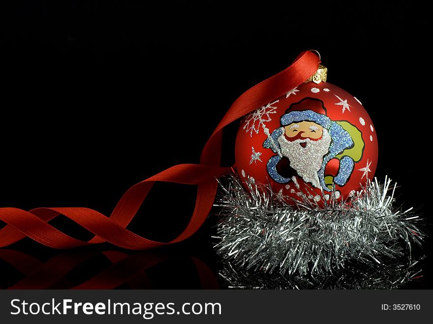 Red christmas tree ball with santa and red ribbon with reflection. Place for text