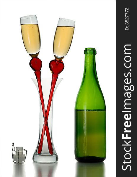 Pair of original wine glasses with champagne and bottle isolated on white background. Pair of original wine glasses with champagne and bottle isolated on white background