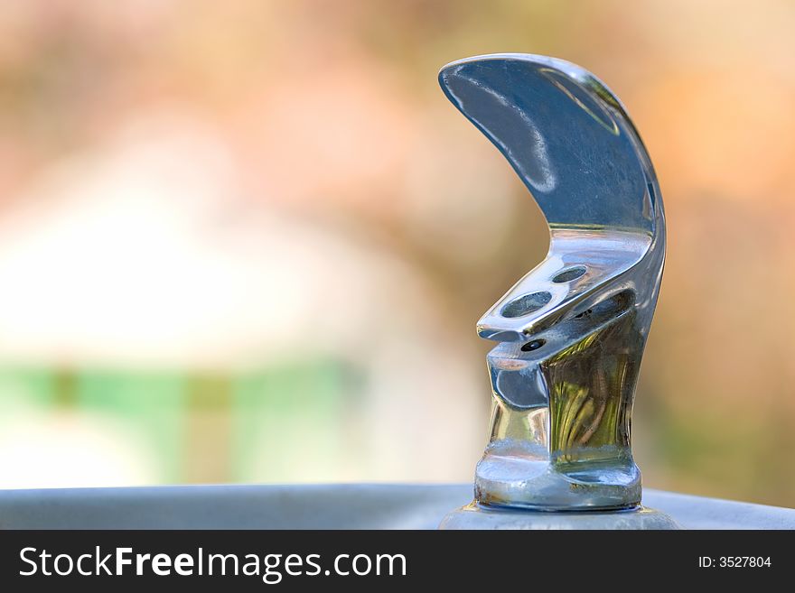 Outdoor drinking fountain with blurred background