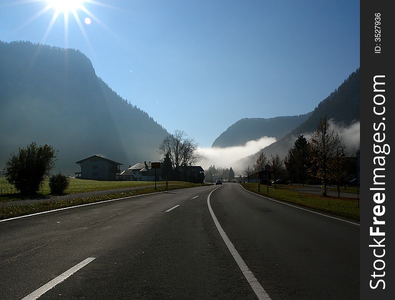 Alpes, Bavaria, Germany - Inzell City . Highway to Mountains . In the distance - the mist in the Gorge . Alpes, Bavaria, Germany - Inzell City . Highway to Mountains . In the distance - the mist in the Gorge .