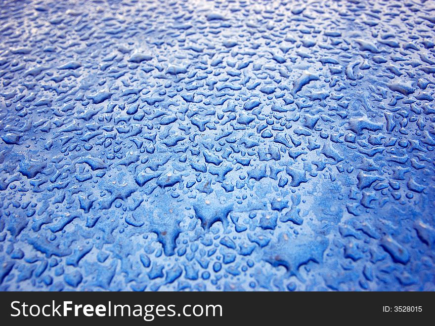 Irregular bater drops on the blue background texture. Irregular bater drops on the blue background texture