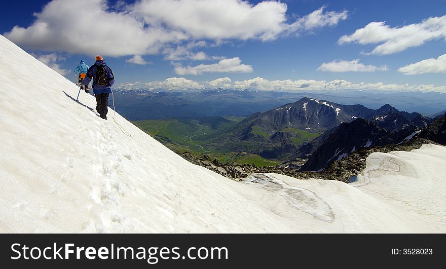 Two climbers high above the wild valley. Two climbers high above the wild valley